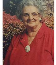 Kelly's grandmother, a woman with curly short hair and earrings