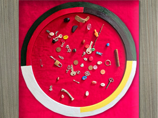 Colored mat with various bones and trinkets on it.